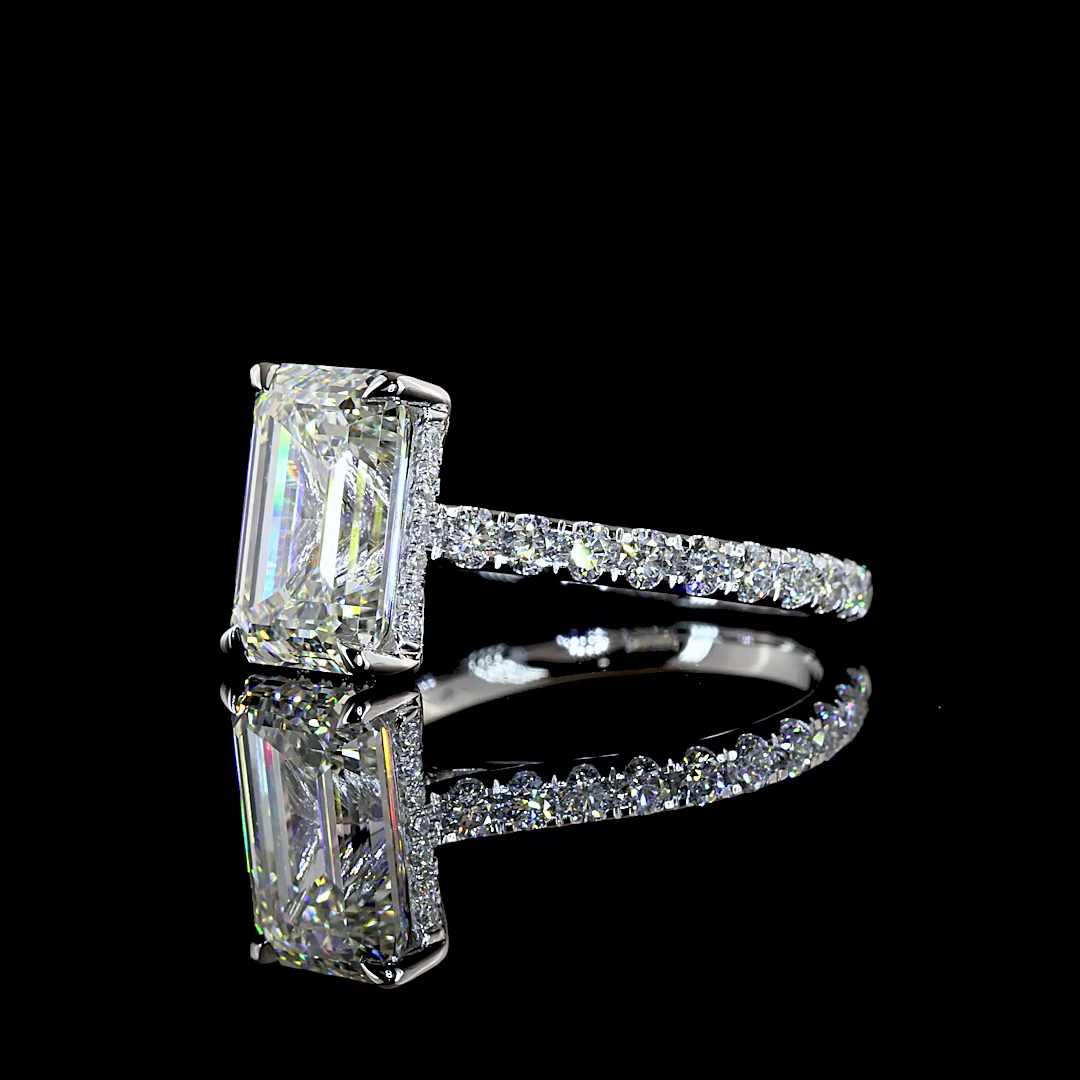 3.93ctw emerald cut lab grown diamond engagement ring in 14K white gold with a pavé band.