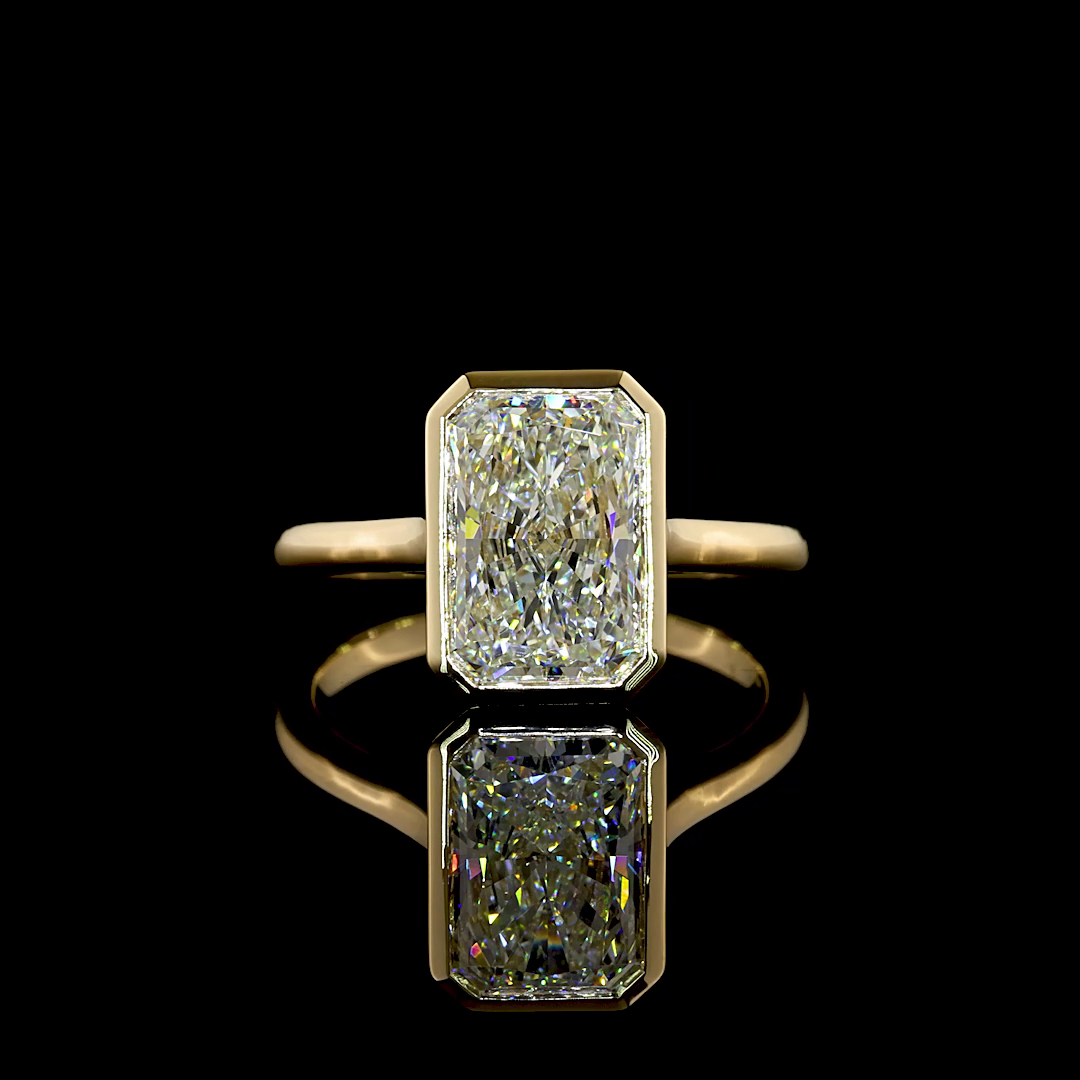 3.17ct radiant cut lab grown diamond engagement ring in a 14k yellow gold bezel setting.