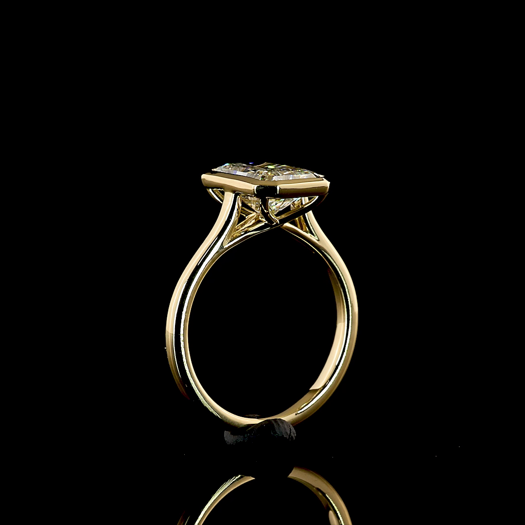 Side view of a 3.17ct radiant cut lab diamond ring in a 14k yellow gold bezel setting.
