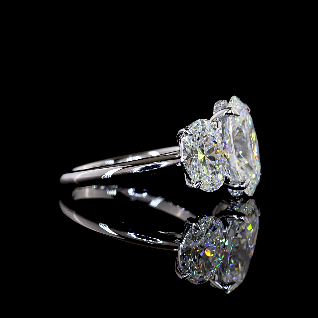 Side view of a 6.15ctw lab grown oval three stone engagement ring in 14k white gold.