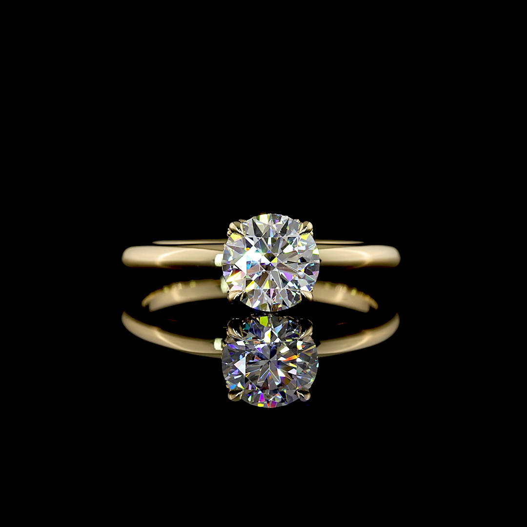 A 14k yellow gold engagement ring, set with a 1.08ct round cut lab grown diamond, surrounded by a thin hidden halo, on a plain band. The ring is rotating 360 degrees on a black background.