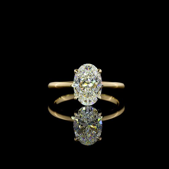 A 360 rotating video of a 2.12ct oval lab grown diamond in a simple solitaire setting in 14k yellow gold, on a black background.