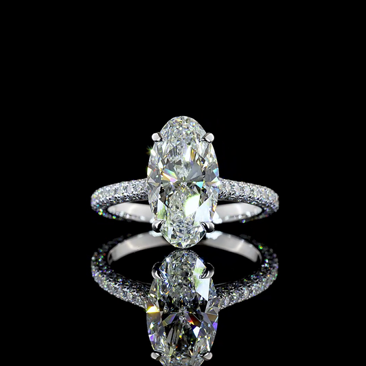 A 360 rotating video of a 14k white gold engagement ring on a black background. The ring is set with a 2.66ct moval cut lab grown diamond, with a hidden halo and a three sided pave diamond band.